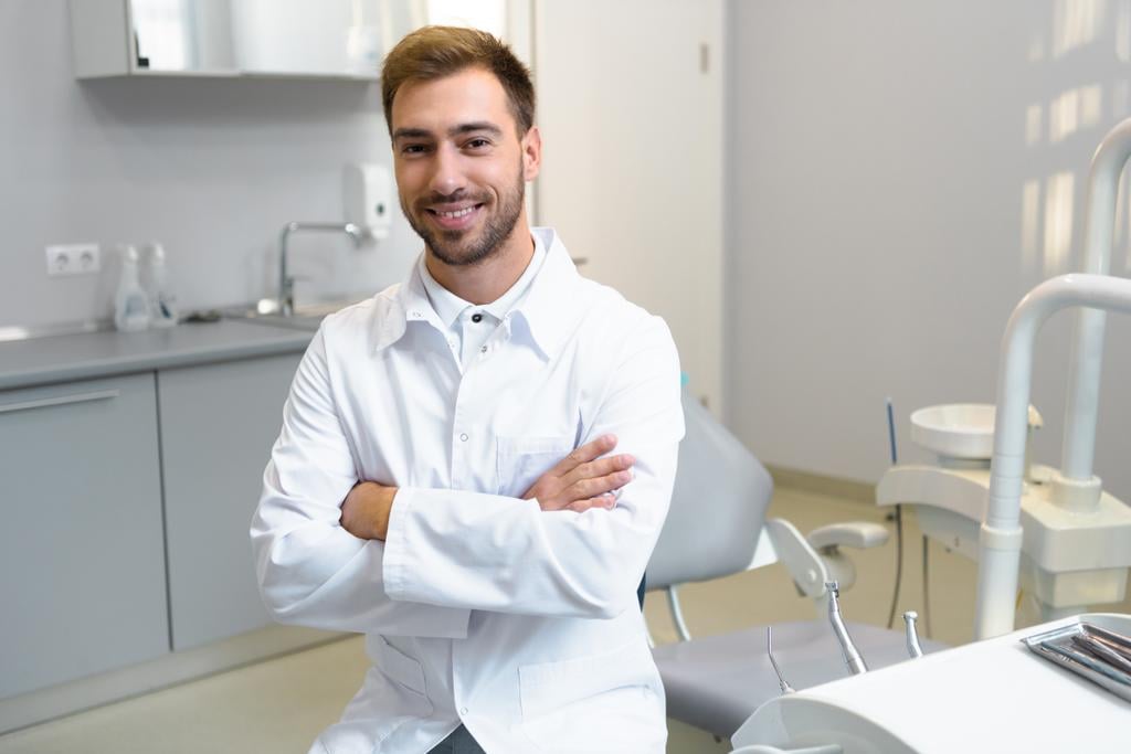 stock-photo-happy-young-dentist-crossed-arms